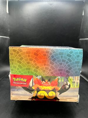 the box of the pokemon toy is sitting on a black surface