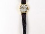 an image of a watch on a white surface with a white background