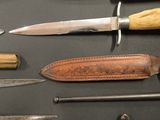 many different types of knives on display on a table