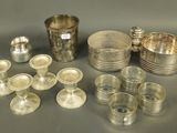 several silver plated dishes and cups are arranged on a table