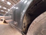an image of a car in a garage with a flat tire