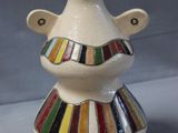 a white vase with a multicolored design on it