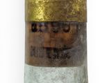 a close up of a bottle of liquor on a white surface