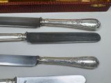 five different types of knives and a box on the table