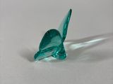 a glass bird that is sitting on a table