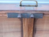 a wooden trunk with a handle on it
