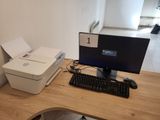 a computer on a desk with a printer on it
