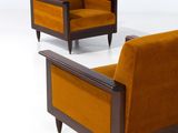 pair of mid - century lounge chairs with orange velvet upholstered seats