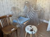 several chairs and a stool in a room with a wallpapered wall