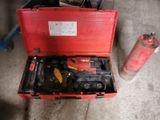 a red tool box with tools in it on the floor