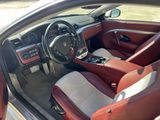 the interior of a car with red leather seats and a steering wheel
