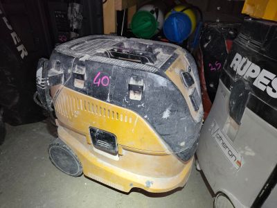 a yellow and black vacuum cleaner in a garage