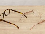 a pair of glasses sitting on top of a wooden table