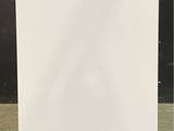 an image of a white refrigerator sitting on a concrete floor