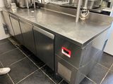 a stainless steel counter top in a kitchen with stainless steel appliances