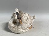 figurine en porcelaine représentant un canard tenant un poisson dans son bec