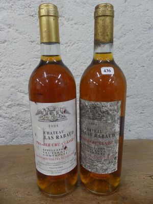 deux bouteilles de vin posées sur une table l'une à côté de l'autre
