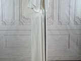 a white dress on a stand in a room
