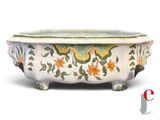 a white bowl with a green and yellow design on it