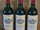 three bottles of wine sit on a wooden shelf in front of a wooden wall
