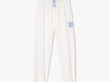 un pantalon de survêtement blanc avec un logo bleu sur le côté