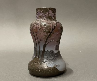a vase that has a picture of a tree on it