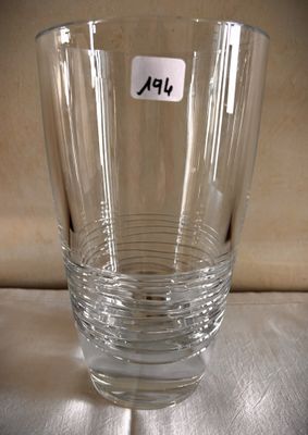 a clear glass with a sticker on it sitting on a table