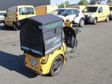 a motorcycle with a box on the back parked in a parking lot