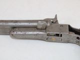 an old gun on a white table with a white background