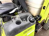a yellow and black tractor with a tank on the back of it