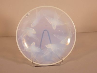a white plate with fish on it on a stand