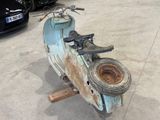 a scooter that is sitting on a stand in a parking lot
