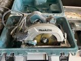 a blue tool box with a circular saw in it