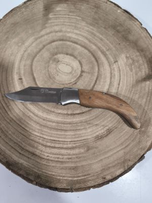 a knife that is sitting on top of a piece of wood