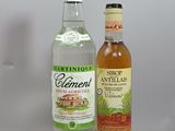two bottles of alcohol sitting on a shelf next to each other