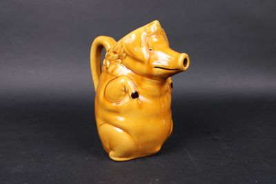 an image of a small yellow ceramic animal figurine on a black background