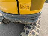 a yellow excavator that is sitting in the parking lot