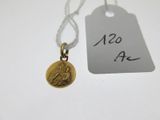 a close up of a gold coin with a tag attached to it