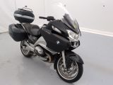 a black and silver motorcycle parked in a white room