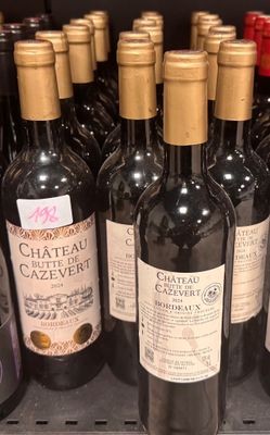 many bottles of wine sitting on a shelf in a store