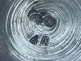 a close up of a metal object with a smiley face on it