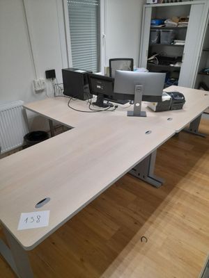 a desk with two monitors and a keyboard on it
