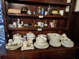 a wooden china cabinet with a lot of plates and bowls on it