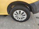 a close up of a yellow car with a flat tire