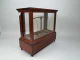 a small wooden case with a clock inside of it