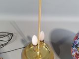 a lamp that is sitting on a table next to a bowl