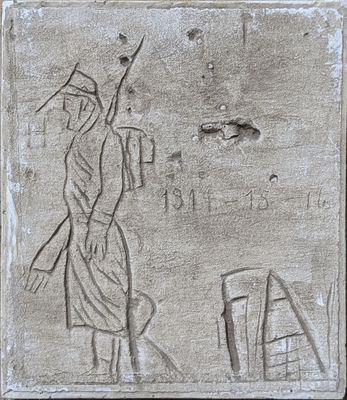 a stone plaque with a drawing of a man and a woman