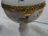 a white porcelain egg with a gold decoration on it