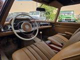 a view of the inside of a car with a steering wheel and dashboard