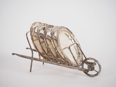 a silver plate holder with a bunch of plates on it